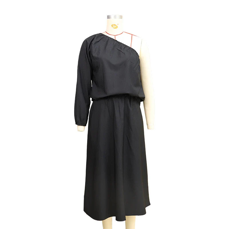 Elegant two-piece set with oblique shoulder blouse and midi skirt in black colour