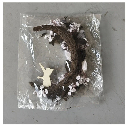 Spooktacular Halloween garland featuring a blend of dried white flowers, black roses, and mystical moon cat ornaments