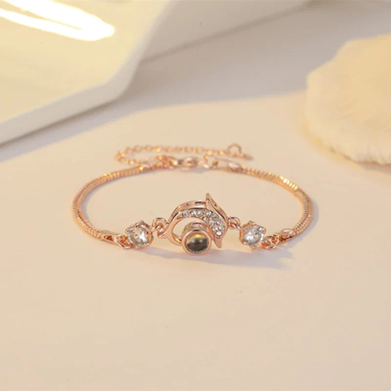 Couple wearing vibrant, projection couple bracelets in rose gold and platinum finishes