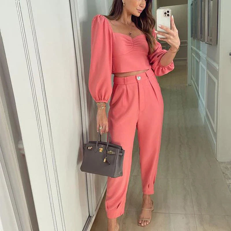 A stylish two-piece set with a square neckline top and ankle-tie trousers, made of premium polyester fabric and available in a range of vibrant solid colours.