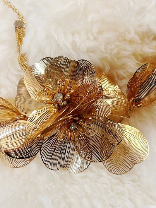 Elegant metal flower charm earrings and necklace set with delicate floral designs and metallic accents