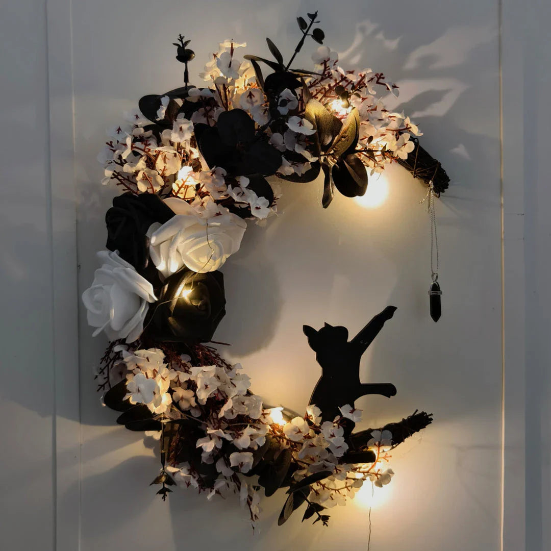 Spooktacular Halloween garland featuring a blend of dried white flowers, black roses, and mystical moon cat ornaments
