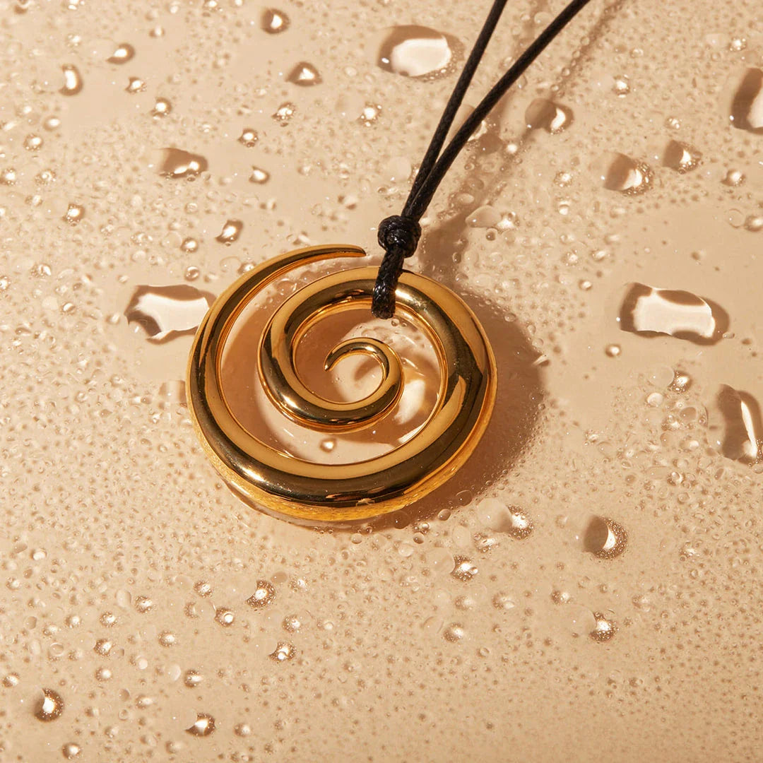 Elegant 18K gold-plated spiral circle pendant necklace made of premium stainless steel with a timeless design
