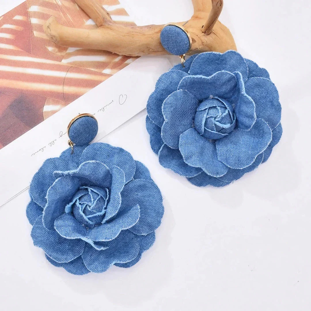 Elegant denim drop earrings with intricate details, a versatile accessory that adds a touch of refined British style to any outfit.