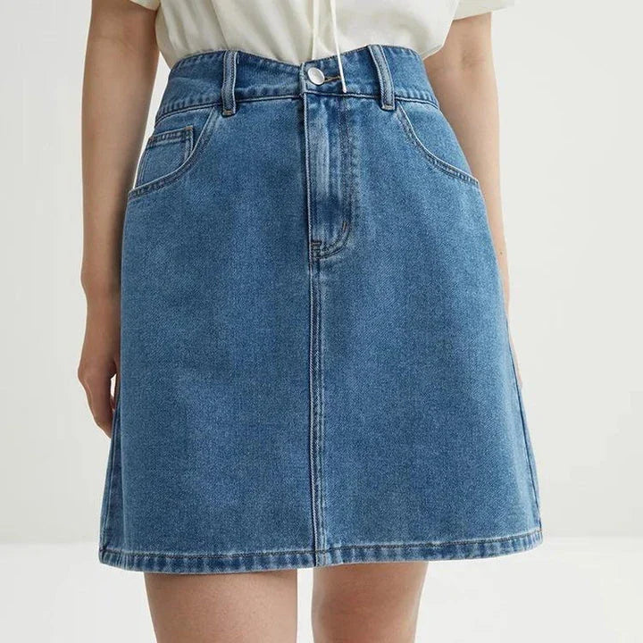 Chic high-waisted denim skirt in a classic blue shade, featuring an A-line silhouette and a flattering empire waistline.