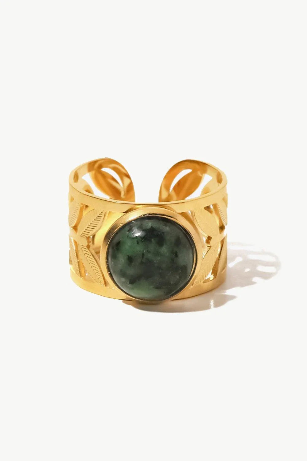 Elegant 18K gold-plated malachite leaf ring in a flat lay, studio style photograph