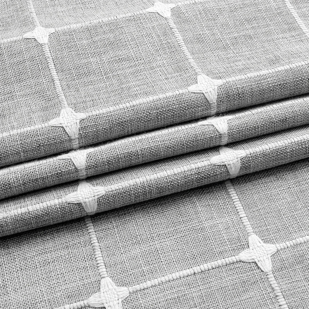 Elegant jacquard linen shower curtain with a geometric pattern and charming tassel accents, available in multiple sizes and colours for a premium bathroom upgrade.