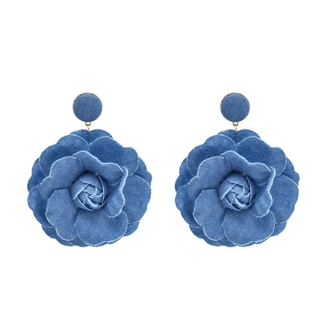 Elegant denim drop earrings with intricate details, a versatile accessory that adds a touch of refined British style to any outfit.