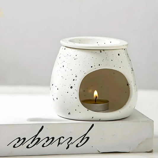 Elegant ceramic aroma diffuser with a unique spotted glaze design, perfect for creating a calming atmosphere in any room.