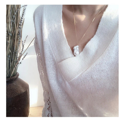 Elegant freshwater pearl necklace with a unique fish tail-shaped pendant and a delicate O-shaped chain
