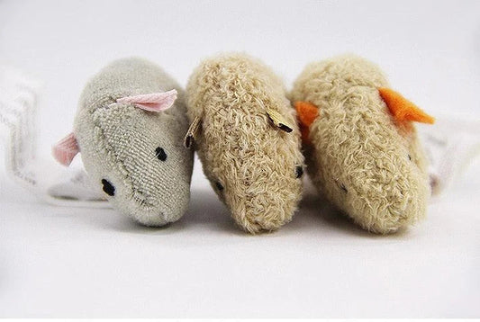 Three plush mice in various colours, designed as engaging toys for playful cats in the UK.