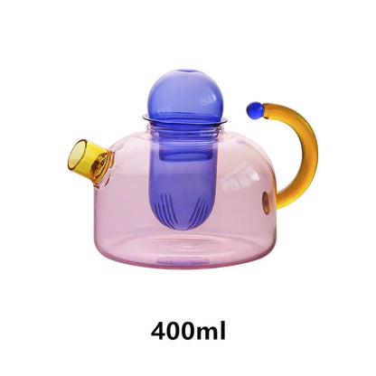 Elegant glass teapot and teacup set in vibrant contrasting colours, designed for a refined tea experience