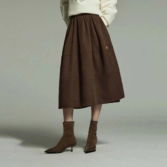 A stylish and sophisticated mid-length A-line pleated skirt with pockets, crafted from high-quality twill fabric for durability and comfort.