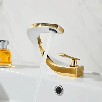 Elegant brass gold and white bathroom basin faucet with sleek, contemporary design