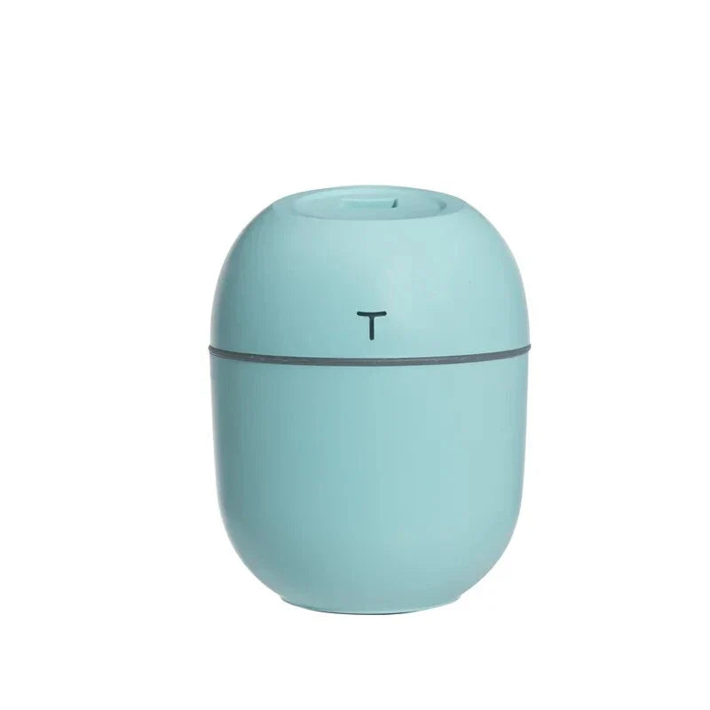 Compact ultrasonic humidifier and aroma diffuser with LED night light, designed for use in home or office spaces.