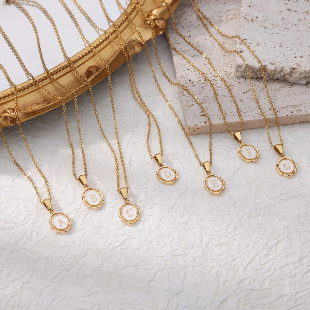 Elegant gold-tone letter pendant necklace with innovative drip oil design and integrated fitness tracker