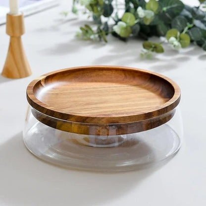A transparent glass storage canister with a wooden lid, offering elegant and functional kitchen storage