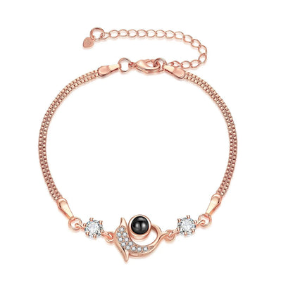 Couple wearing vibrant, projection couple bracelets in rose gold and platinum finishes