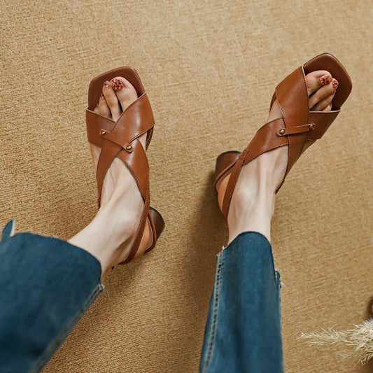 Elegant leather high heel sandals in khaki colour for women, featuring a 5.5 cm square heel, secure buckle strap, and sleek design.