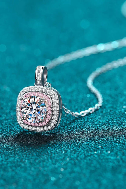 A rhodium-plated sterling silver necklace with a geometric pendant featuring a sparkling Moissanite gemstone over 0.3 carats.