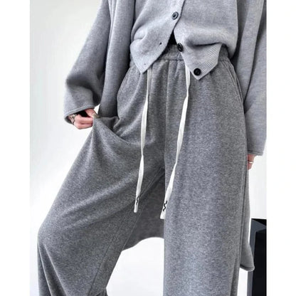 Elegant high-waist drawstring trousers in black, featuring a wide-leg cut and stylish lace-up pockets