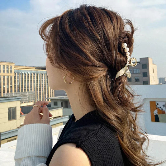 Elegant gold-toned mermaid tail hair clips adorned with faux pearls, creating a captivating and enchanting accessory for mermaid lovers.