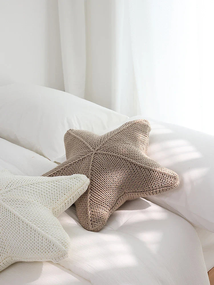 Artfully hand-knitted starfish-shaped cushion in a range of sophisticated colour options, providing plush comfort and coastal charm for any living space.