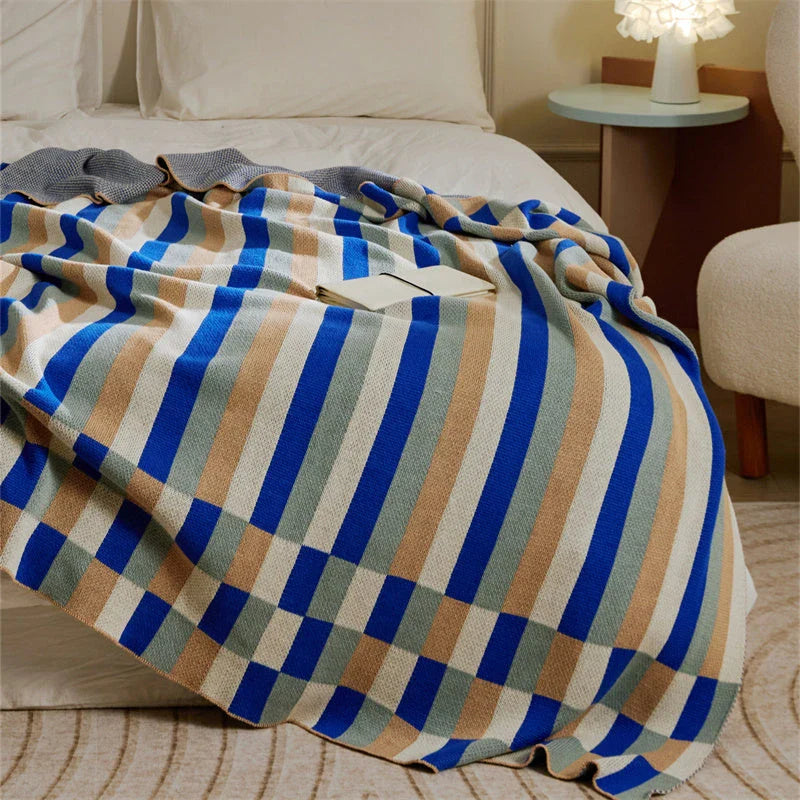 Cosy 100% cotton striped plaid throw blanket in vibrant orange and blue hues, perfect for adding rustic charm to any living space.