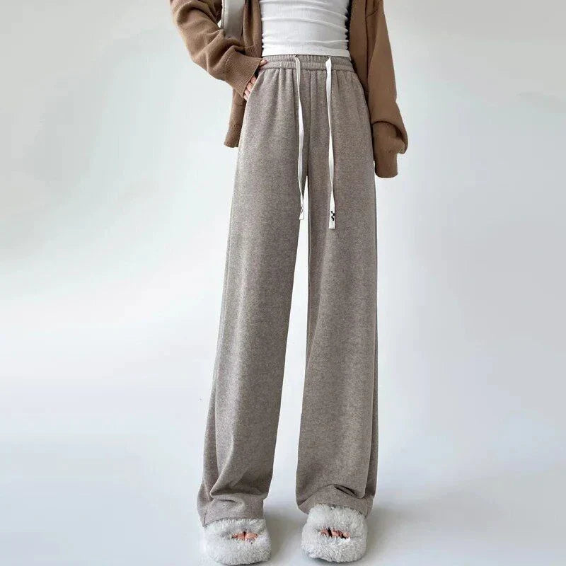 Elegant high-waist drawstring trousers in black, featuring a wide-leg cut and stylish lace-up pockets