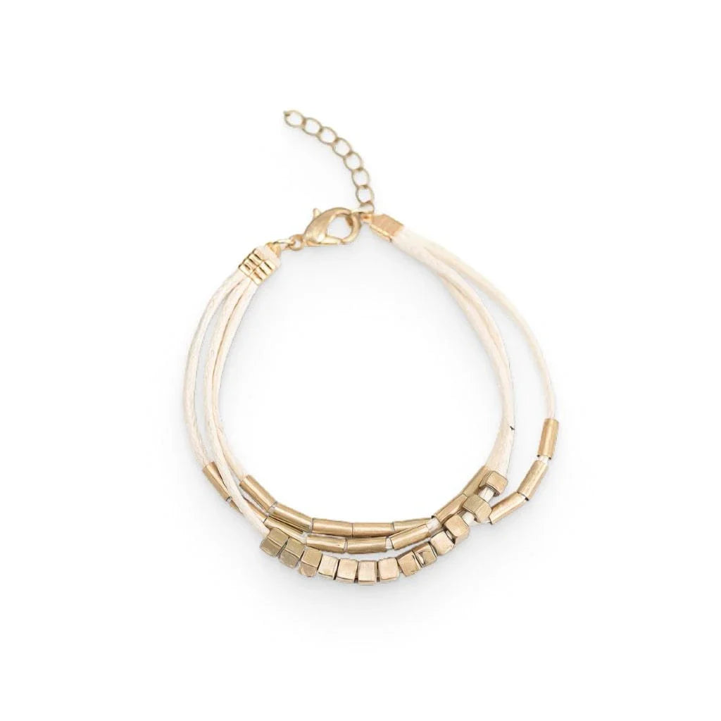 Elegant layered bracelet with beige leather and gold-coloured beads, a versatile accessory for modern British style