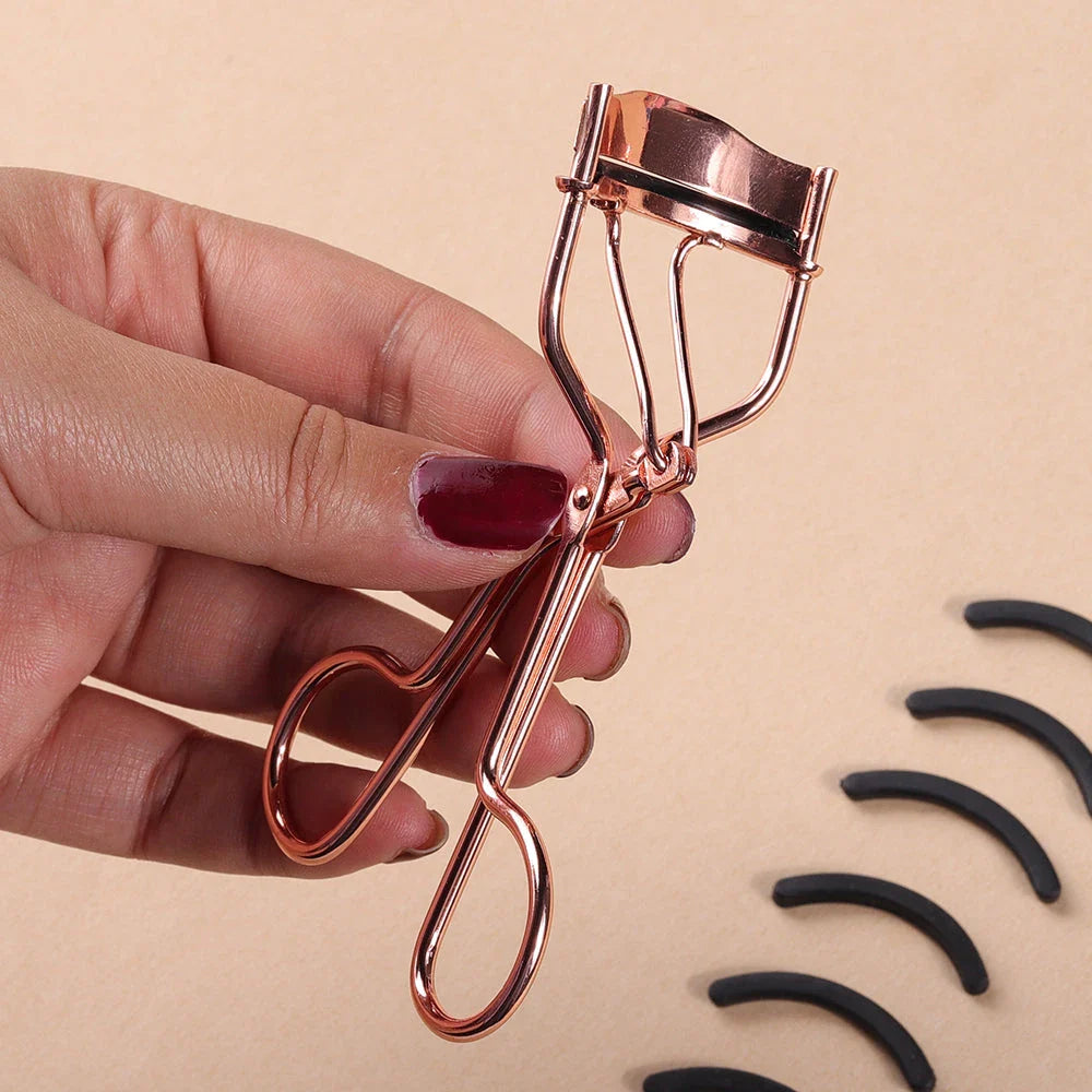Rose gold eyelash curler with a silicone pad for gentle, long-lasting lash curling