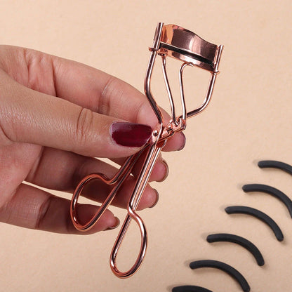 Rose gold eyelash curler with a silicone pad for gentle, long-lasting lash curling