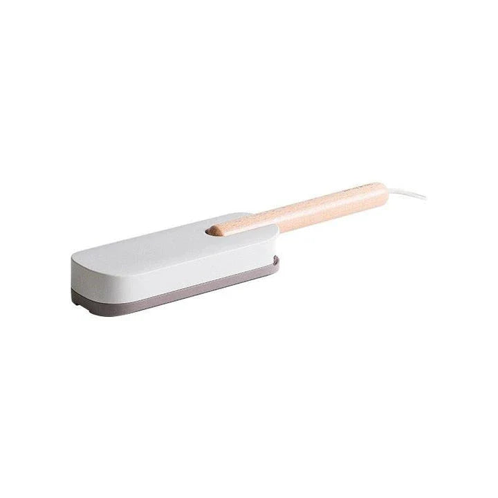 Premium pet hair removal brush with grey handle and bristles, designed for use in UK homes