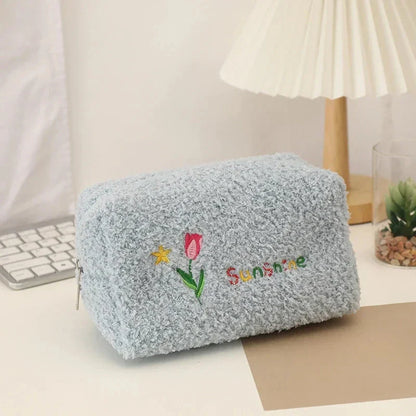 Elegant embroidered flowers cosmetic pouch made of soft, plush material in ivory colour