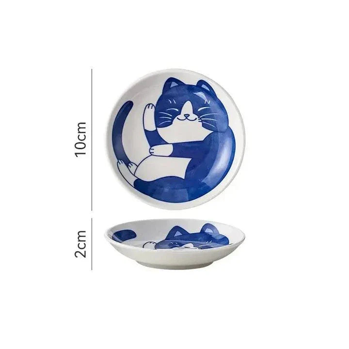 Charming Japanese ceramic sauce dish with a lucky cat design, perfect for serving sauces, sushi, and more.