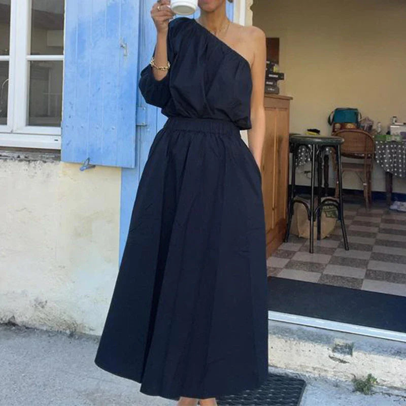 Elegant two-piece set with oblique shoulder blouse and midi skirt in black colour