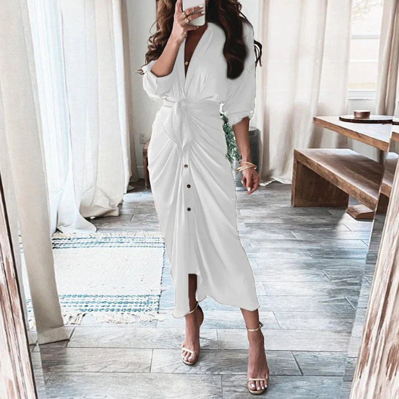 A long sleeve lace-up maxi dress with a deep V-neck and side pockets, available in a variety of floral and solid colour options.