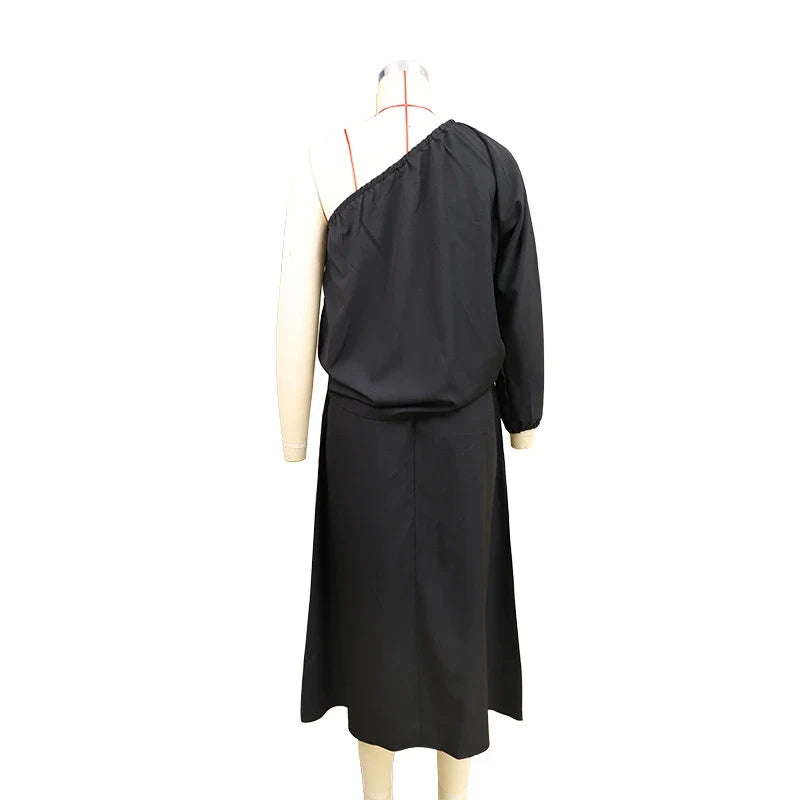 Elegant two-piece set with oblique shoulder blouse and midi skirt in black colour