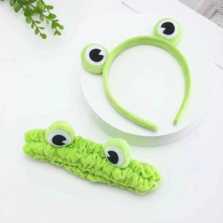Charming frog-themed headband with plush coral fleece material and elastic band for a comfortable, customized fit