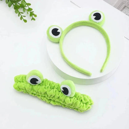 Charming frog-themed headband with plush coral fleece material and elastic band for a comfortable, customized fit