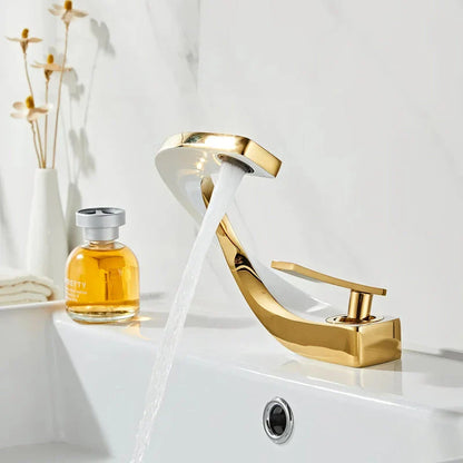 Elegant brass gold and white bathroom basin faucet with sleek, contemporary design