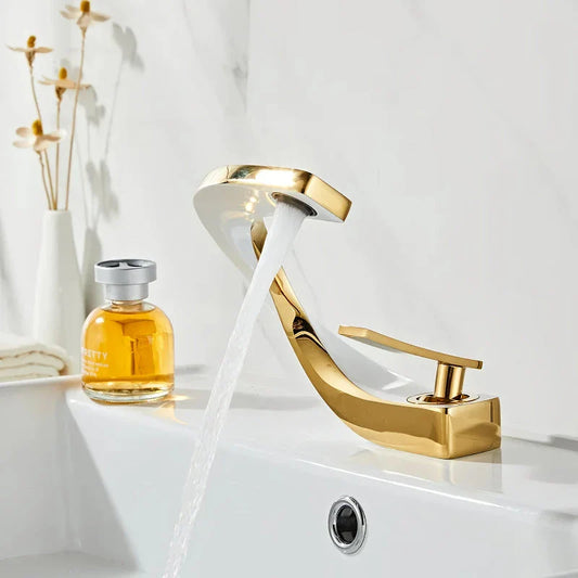 Elegant brass gold and white bathroom basin faucet with sleek, contemporary design