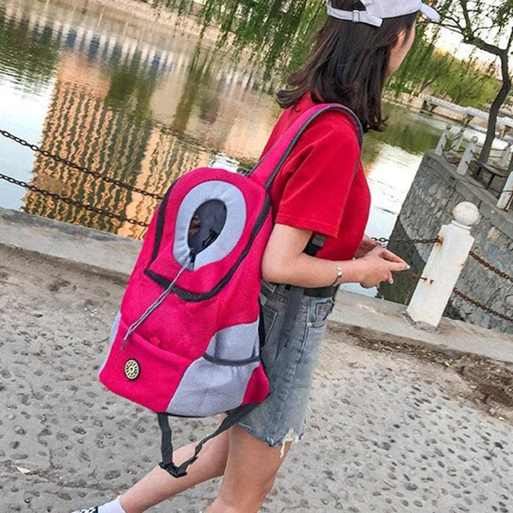 Compact dog carrier backpack made of durable nylon with a convenient front hole for small dogs to poke their head out