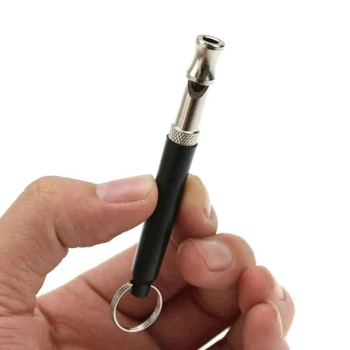 Compact ultrasonic dog training whistle with durable metal and plastic construction for effective communication and reliable performance