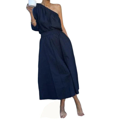 Elegant two-piece set with oblique shoulder blouse and midi skirt in black colour
