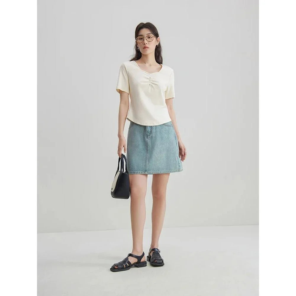 Chic high-waisted denim skirt in a classic blue shade, featuring an A-line silhouette and a flattering empire waistline.