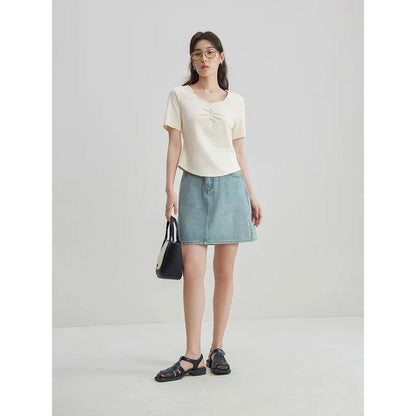 Chic high-waisted denim skirt in a classic blue shade, featuring an A-line silhouette and a flattering empire waistline.