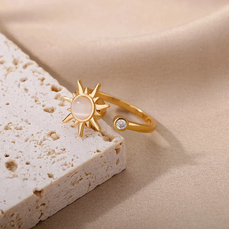 Adjustable stainless steel ring with rotating sun opal centerpiece, offering a modern and sophisticated geometric design for fashionable women