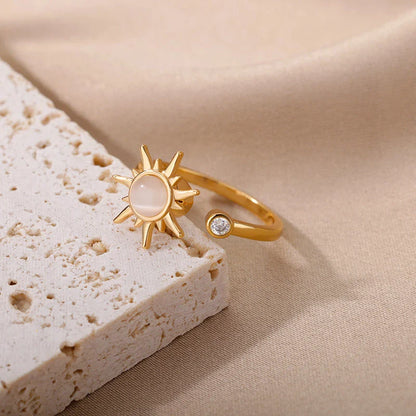 Adjustable stainless steel ring with rotating sun opal centerpiece, offering a modern and sophisticated geometric design for fashionable women