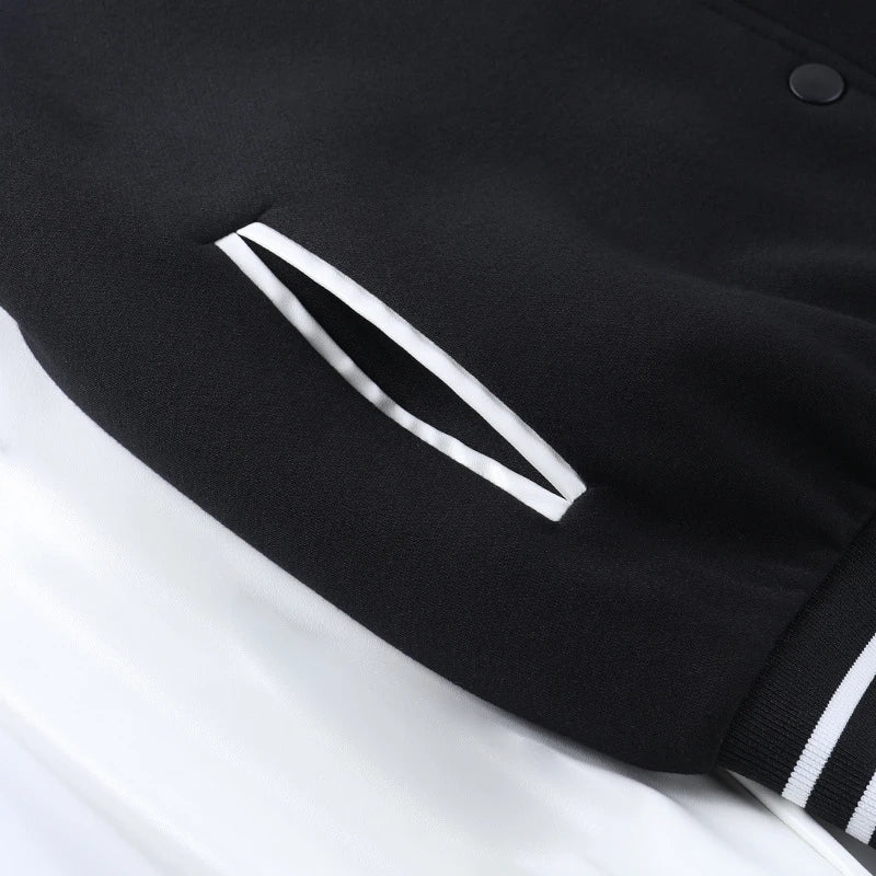 A classic British-style baseball jacket with contrast PU stitching, showcasing a sophisticated and versatile design for casual wear.